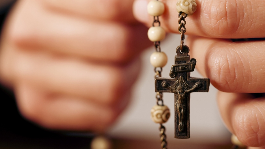 close up photo of hands with rosary