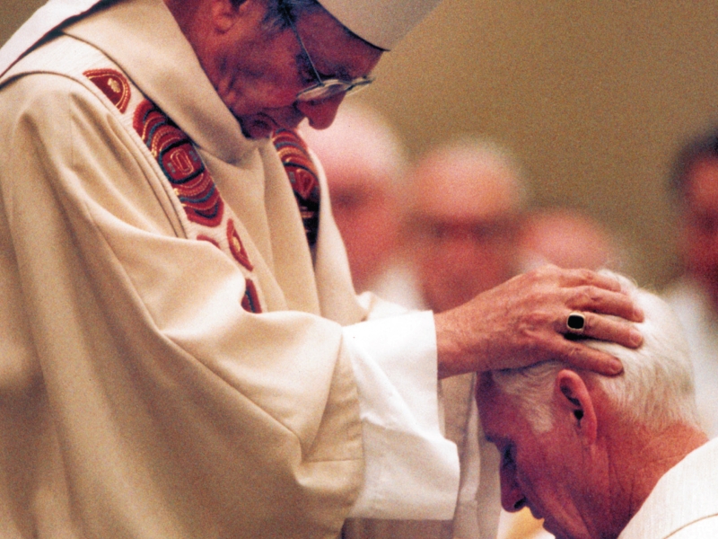 Bishop Kenneth Povish imposing hands during Bishop Mengeling’s ordination as bishop on Jan. 25, 1996.